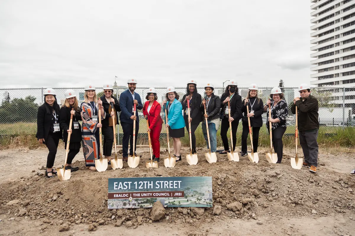 People posing with shovels at East 12th Street groundbreaking ceremony