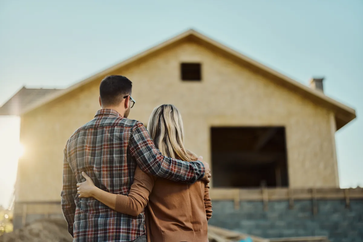Couple watching house building built