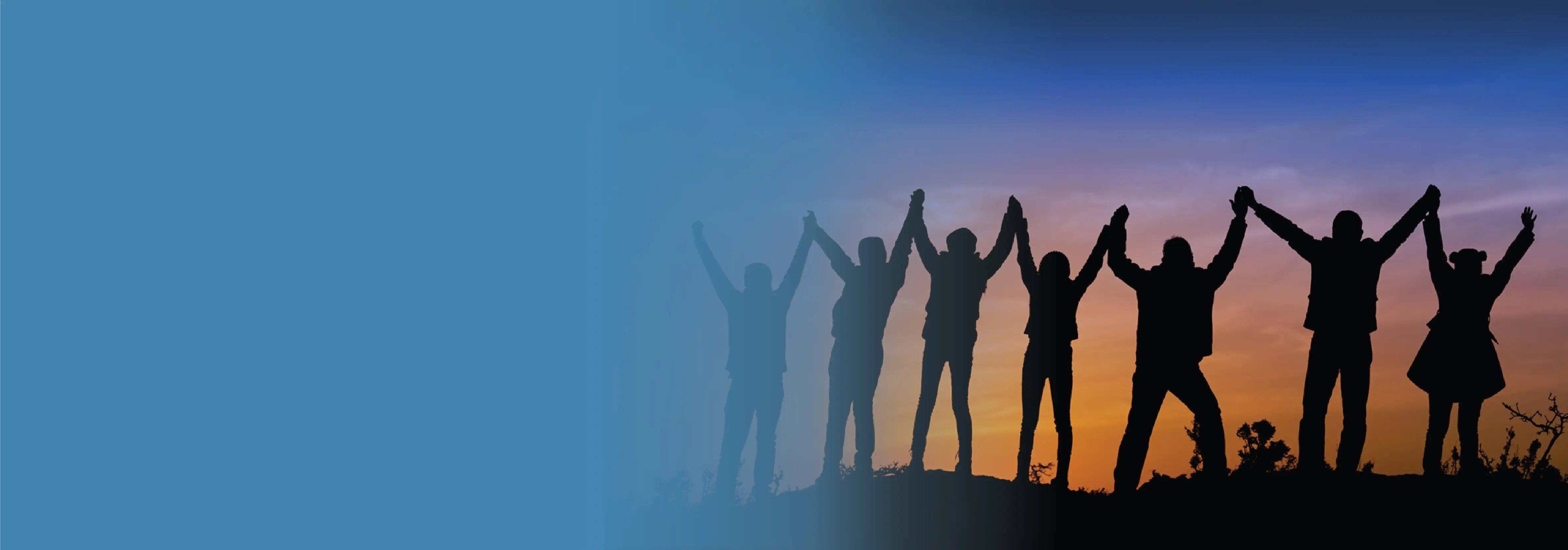 Image silhouette of a group of people holding hands together in the air.