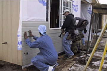 Contractors working on building house