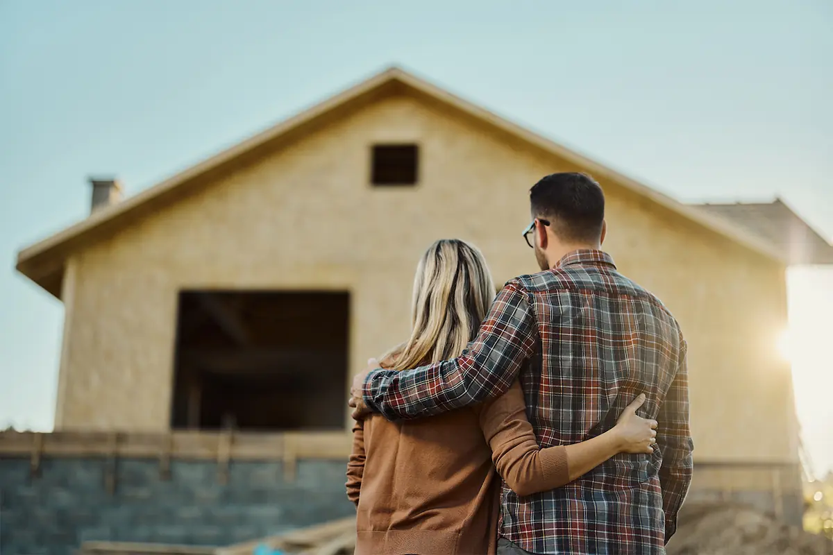 couple looking onto house being built