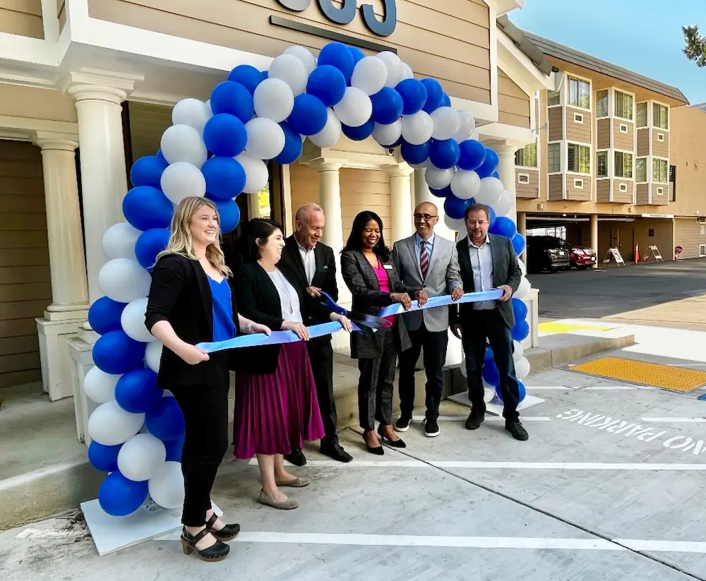 HCD Director Velasquez, Mayor Steinberg and others at cutting the ribbon at the grand opening ceremony.