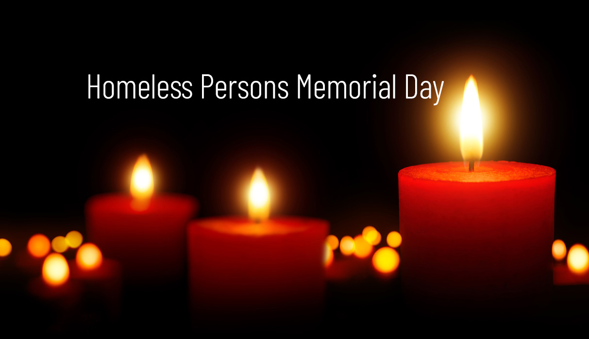Burning candles with the phrase Homeless Persons Memorial Day