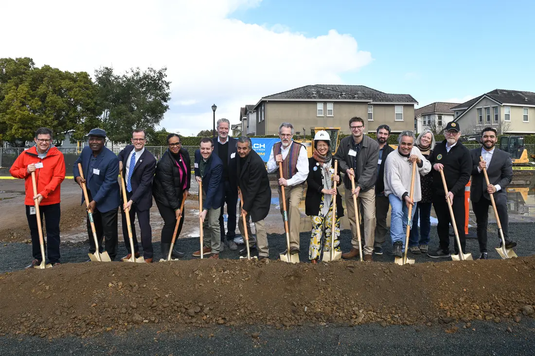 People standing with shovels at the groundbreaking ceremony of Colibri Commons.