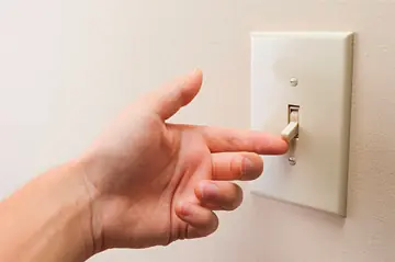 hand toggling light switch